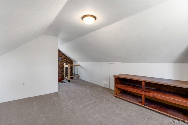 bonus room with carpet and vaulted ceiling