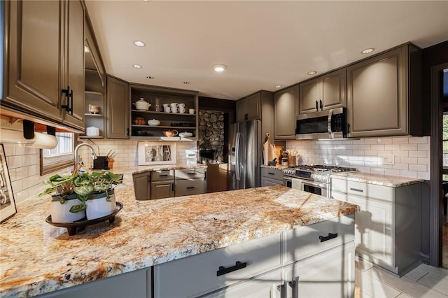 kitchen featuring a peninsula, open shelves, light stone countertops, and appliances with stainless steel finishes