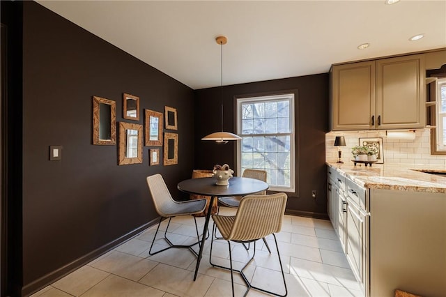 dining room with baseboards and light tile patterned flooring