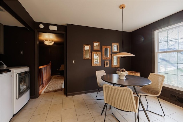 dining room featuring washer and dryer and light tile patterned flooring