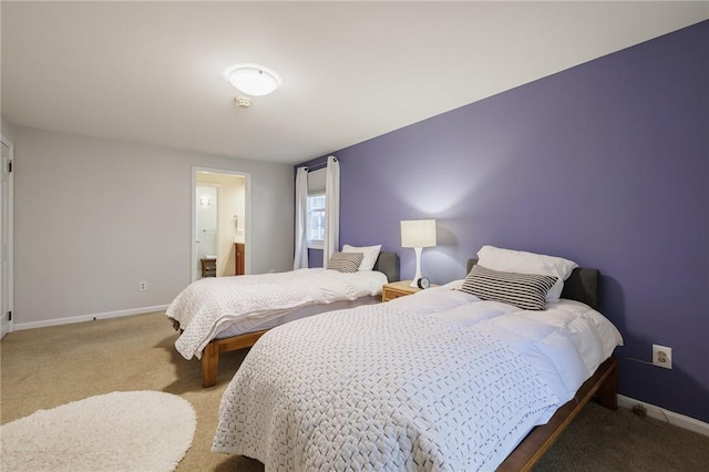 carpeted bedroom with baseboards and ensuite bath