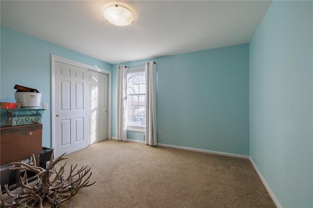 bedroom with carpet flooring and baseboards