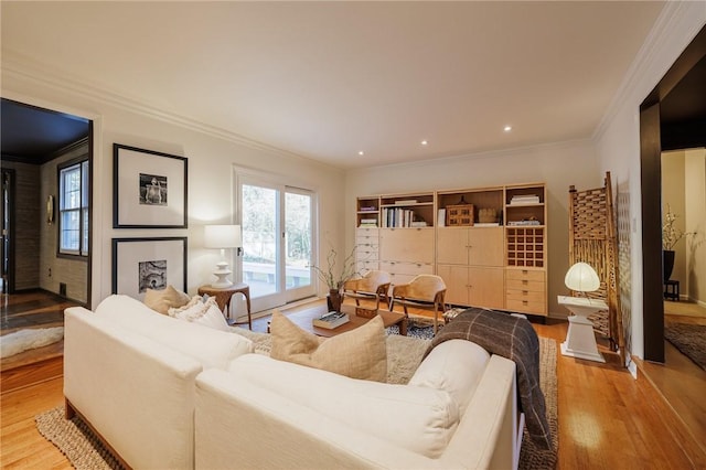 living area with recessed lighting, wood finished floors, and ornamental molding