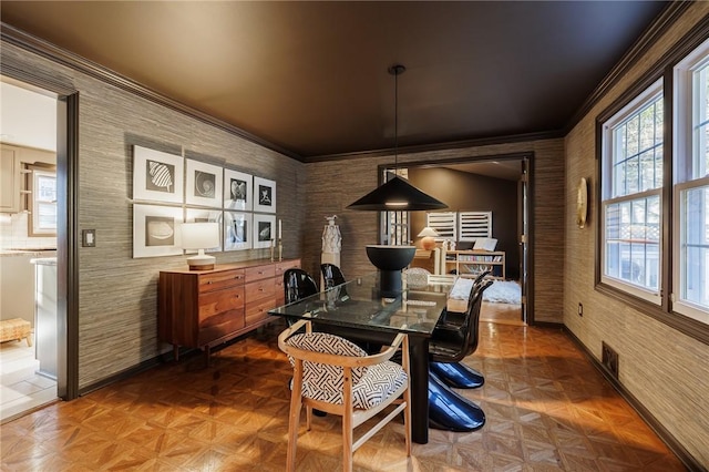 dining area with crown molding and baseboards