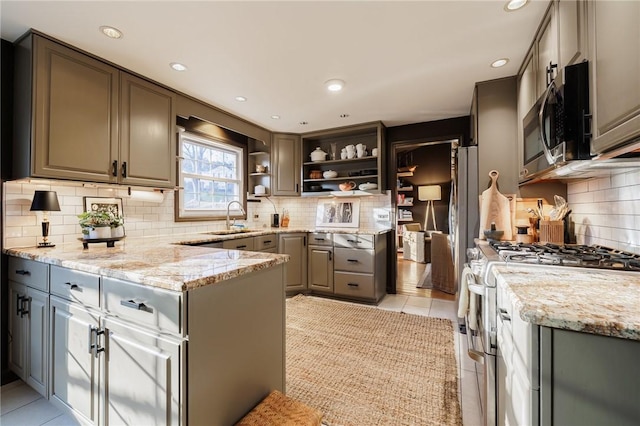 kitchen with open shelves, light stone counters, a sink, appliances with stainless steel finishes, and light tile patterned floors