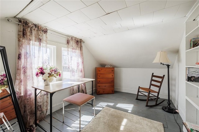 office space featuring baseboards and vaulted ceiling