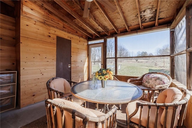 sunroom / solarium featuring vaulted ceiling