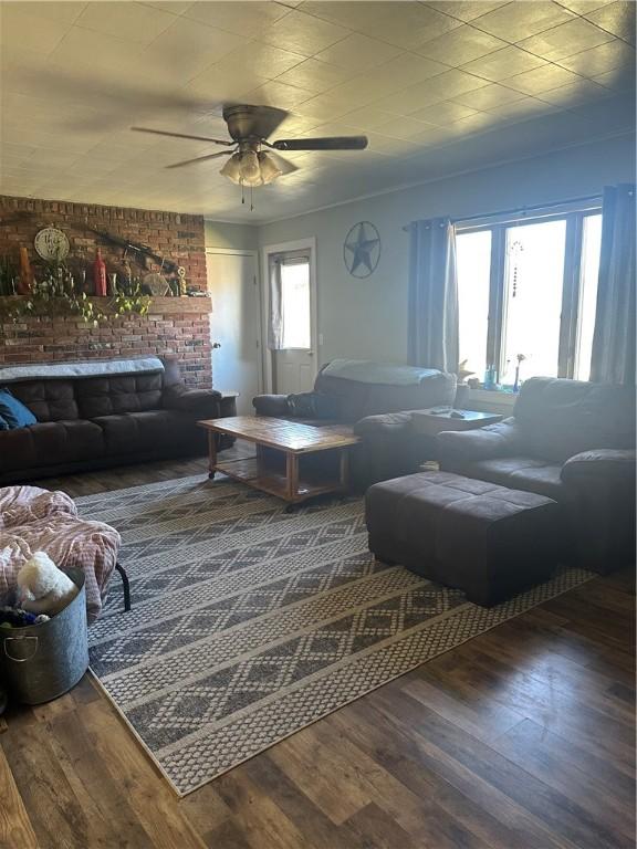 living room with ceiling fan and wood finished floors