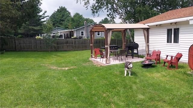 view of yard featuring a gazebo, a patio, a fire pit, and fence