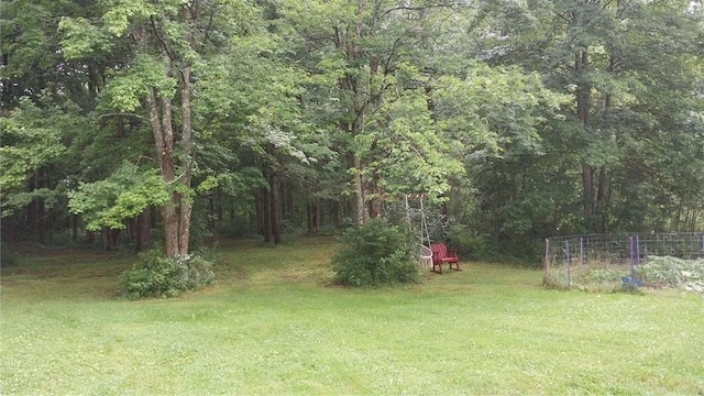 view of yard with a view of trees