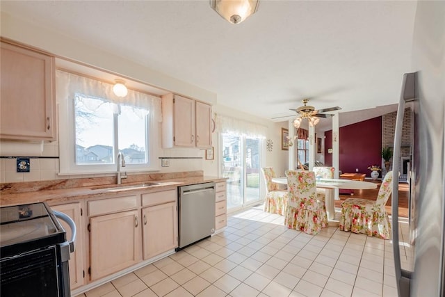 kitchen featuring a sink, appliances with stainless steel finishes, light countertops, light tile patterned floors, and ceiling fan