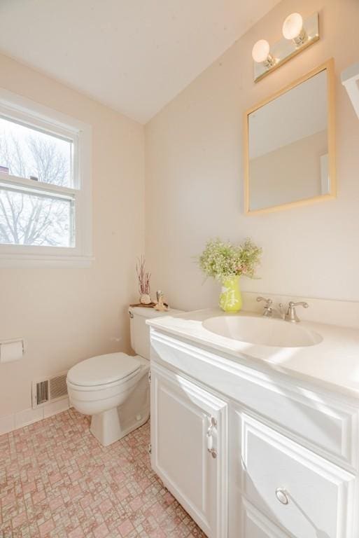 bathroom featuring visible vents, toilet, and vanity