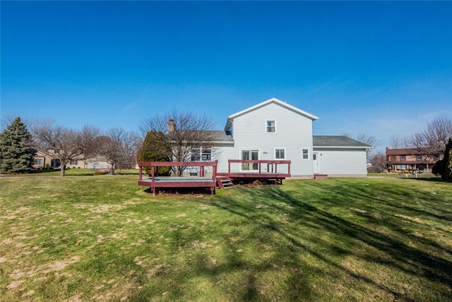 back of house with a lawn and a deck