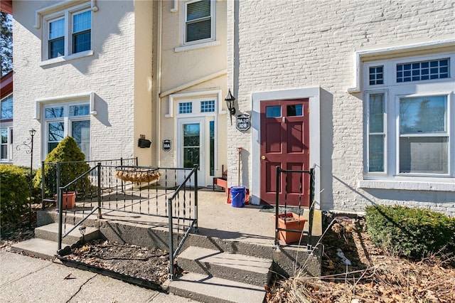 property entrance with brick siding