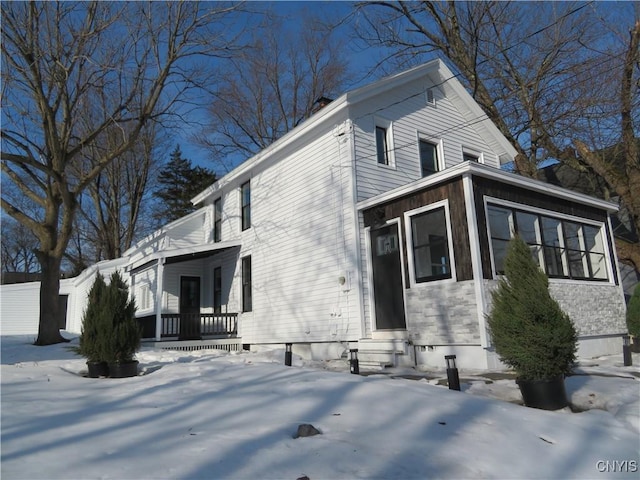 view of snow covered exterior featuring entry steps