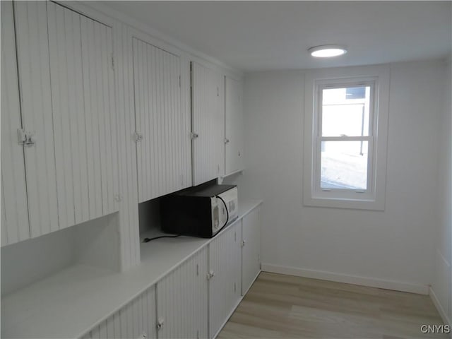 interior space with light wood-style flooring and baseboards