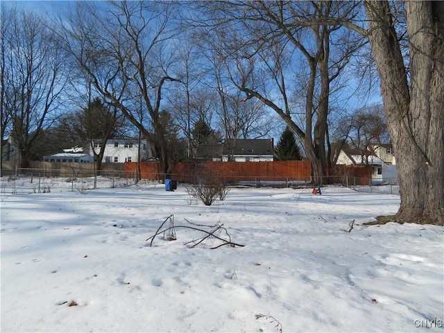 yard layered in snow with fence