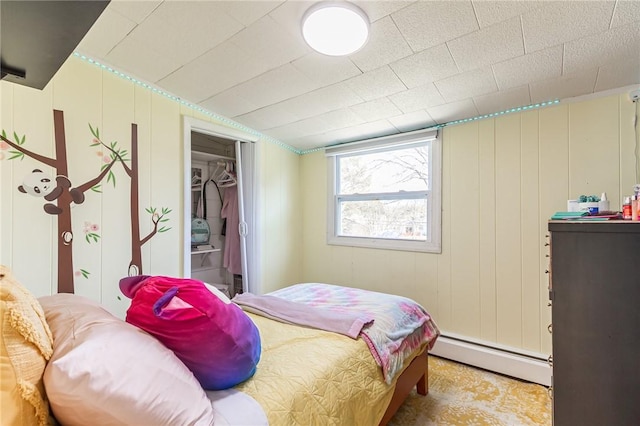 bedroom with a closet and a baseboard radiator