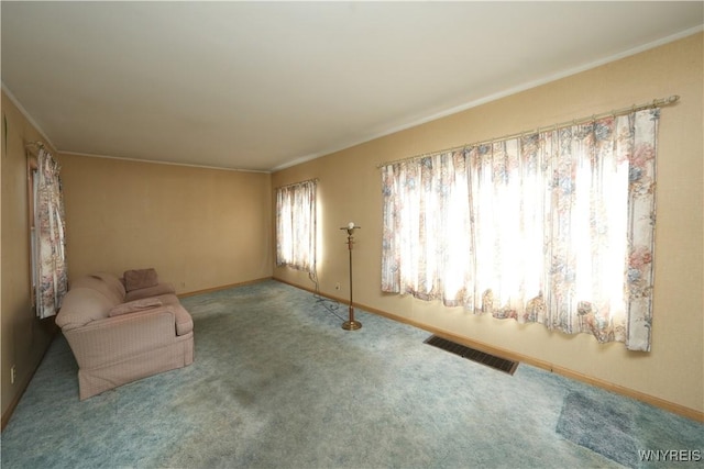 unfurnished room featuring visible vents, baseboards, carpet flooring, and crown molding