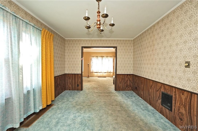 interior space featuring wallpapered walls, visible vents, a wainscoted wall, and ornamental molding