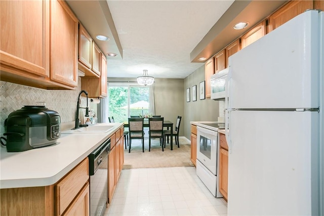 kitchen featuring backsplash, light countertops, recessed lighting, white appliances, and a sink