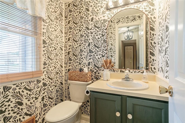 bathroom with wallpapered walls, toilet, and vanity