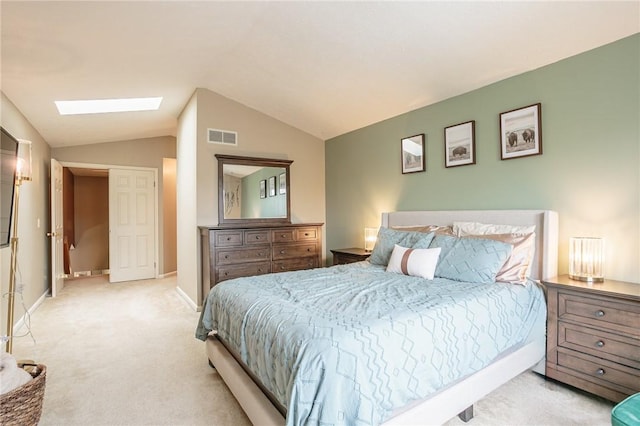 carpeted bedroom featuring visible vents, lofted ceiling with skylight, and baseboards