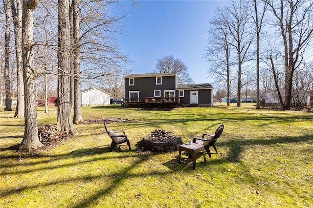 view of yard featuring a fire pit and a deck