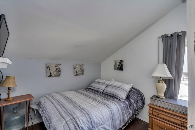 bedroom featuring baseboards and vaulted ceiling