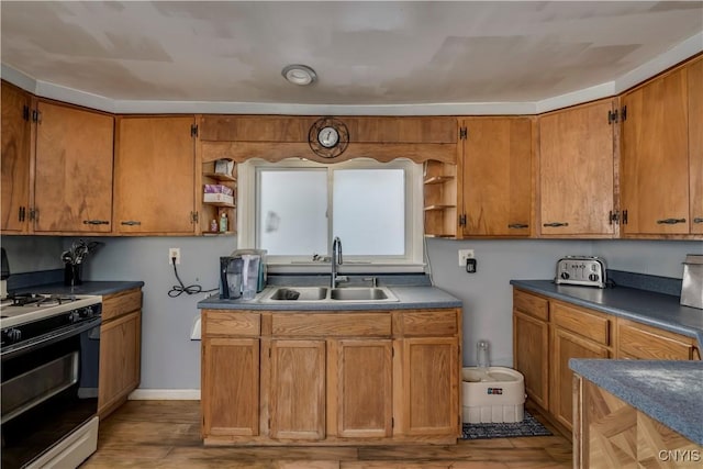 kitchen featuring brown cabinetry, a sink, gas range, and open shelves