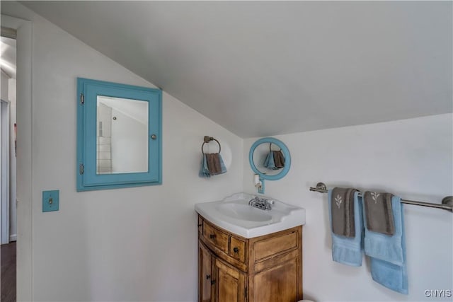 bathroom with vanity and vaulted ceiling