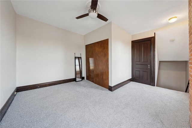 unfurnished bedroom featuring carpet flooring, a ceiling fan, and baseboards