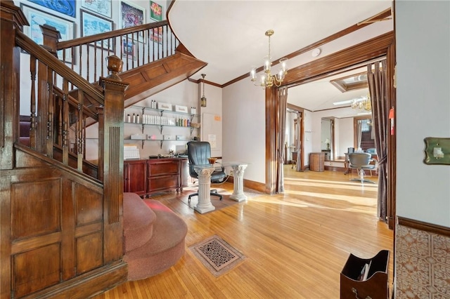 interior space with visible vents, ornamental molding, wood finished floors, baseboards, and stairs