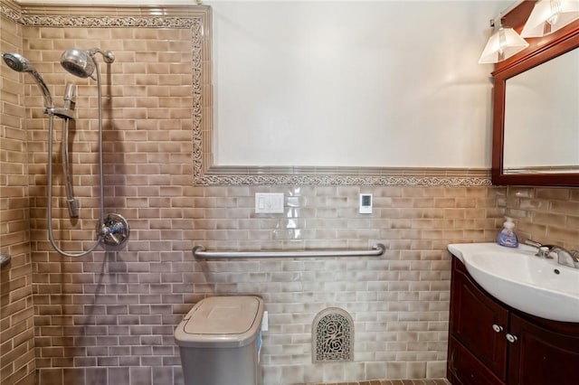 full bathroom featuring tiled shower, toilet, tile walls, and vanity