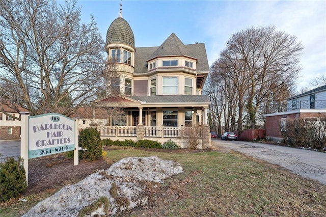 victorian-style house featuring covered porch