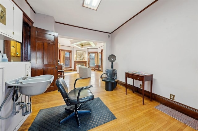 office with baseboards, light wood-style flooring, and ornamental molding