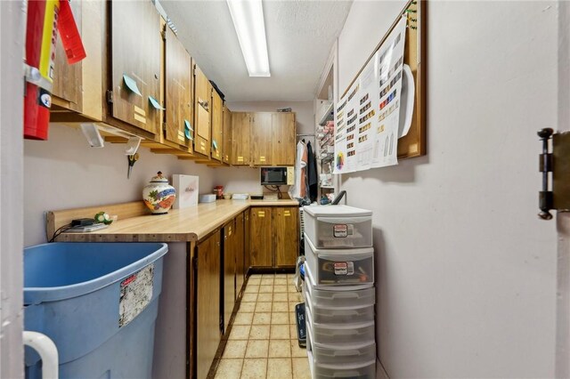 kitchen with light countertops, light floors, and brown cabinets