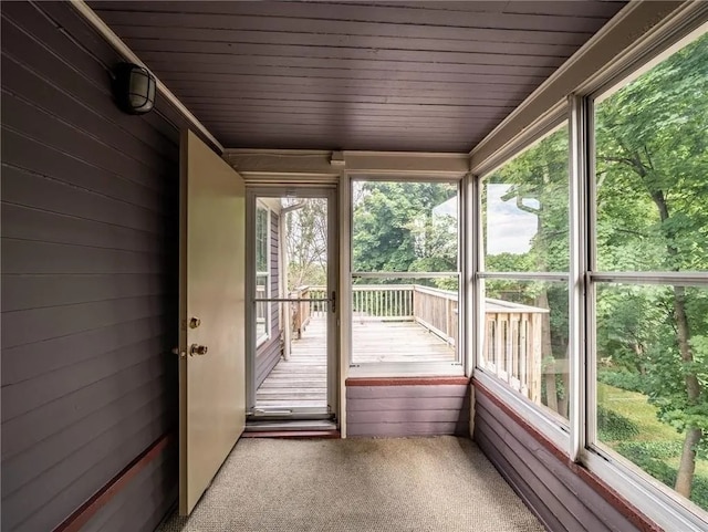 unfurnished sunroom with a wealth of natural light and wood ceiling