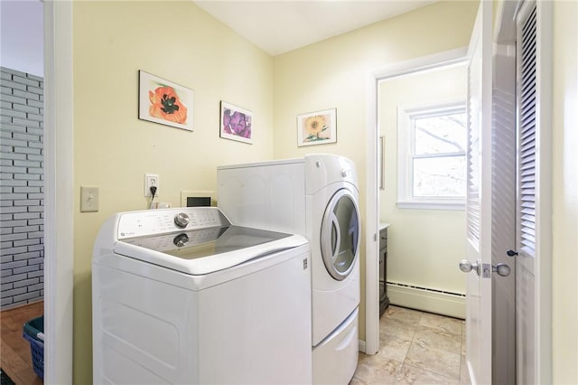 laundry area with washing machine and clothes dryer, laundry area, and a baseboard radiator