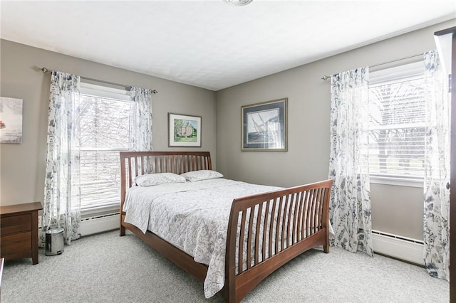 bedroom featuring a baseboard heating unit and carpet flooring