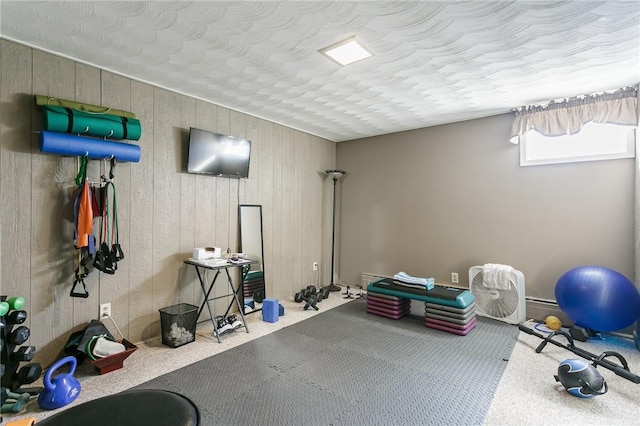 exercise area with carpet and a textured ceiling