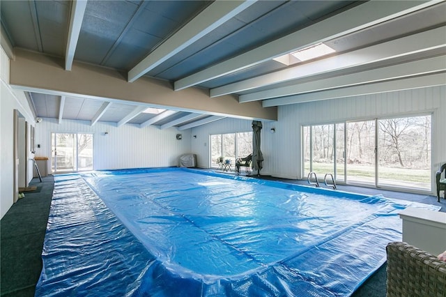 view of pool with a covered pool and a skylight