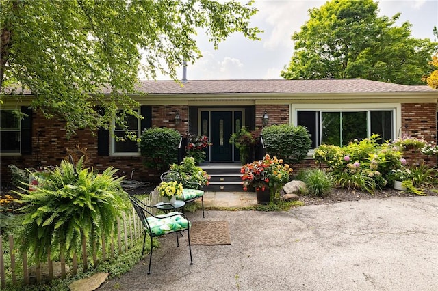 single story home featuring brick siding