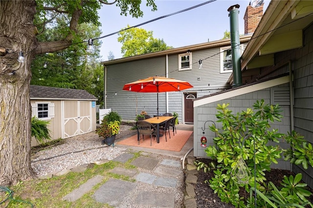 view of patio featuring an outbuilding and a shed