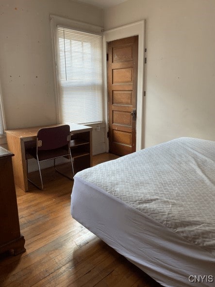 bedroom with hardwood / wood-style floors