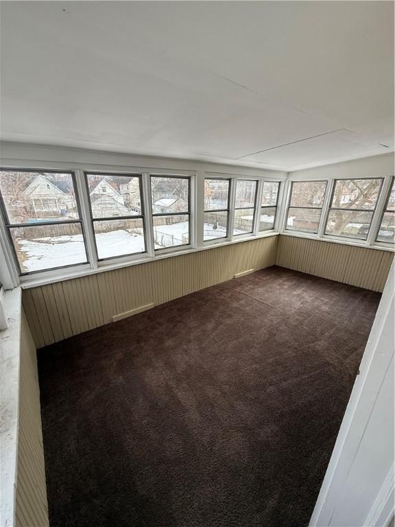 unfurnished sunroom featuring lofted ceiling