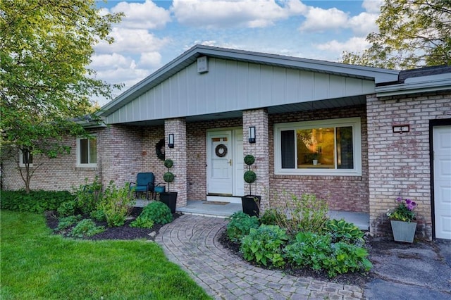 ranch-style house featuring brick siding and covered porch