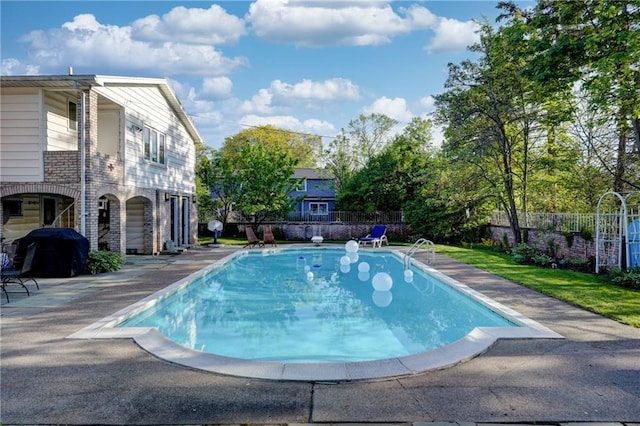 view of pool with a patio area, a fenced in pool, a grill, and fence