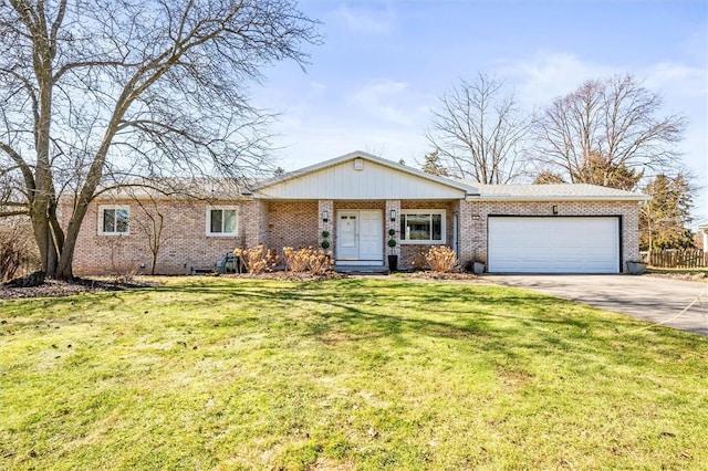 ranch-style house with brick siding, fence, concrete driveway, a front yard, and an attached garage