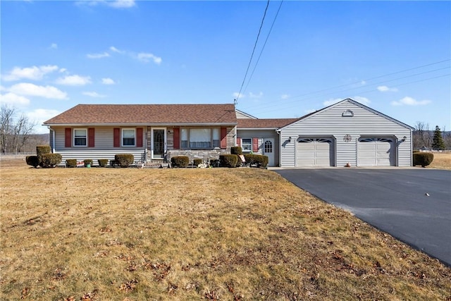 ranch-style home with a front yard, a garage, and driveway